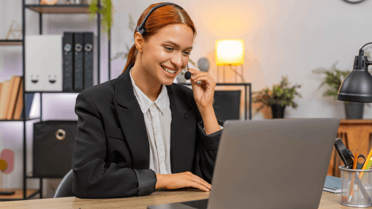 Home services leads customer service representative with headset managing client inquiries on laptop in modern office