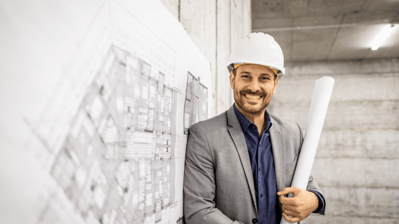 Contractor leads professional in hard hat with blueprints at construction site representing successful project acquisition