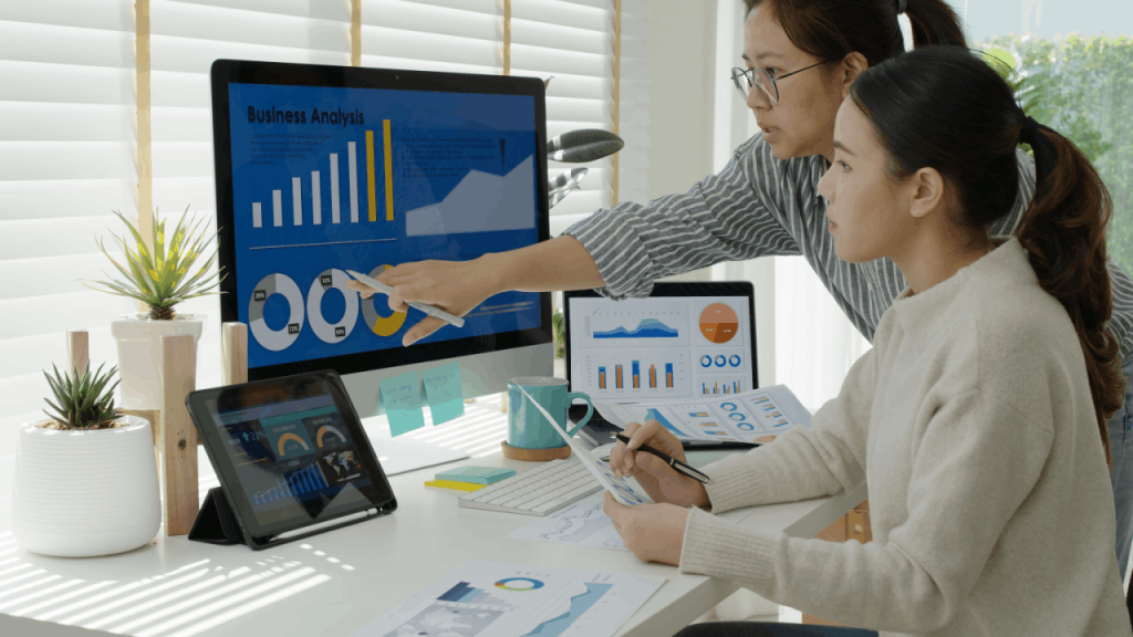 Two marketing professionals reviewing home service company SEO analytics and performance metrics on computer screens